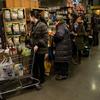 Shoppers at Whole Foods wait on line as the snowstorm begins