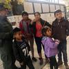 In this Thursday, Nov. 29, 2018 photo, a migrant family from Central America waits outside the Annunciation House shelter in El Paso, Texas