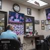 Barber Nat Yunayed watches impeachment hearings while waiting for customers in New York City on Wednesday, Nov. 13, 2019.