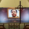 A cross hangs from the cathedral ceiling while Rayshard Brooks is memorialized on a screen during his public viewing at Ebenezer Baptist Church on Monday, Jun 22, 2020, in Atlanta.