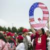 In this Aug. 2, 2018, file photo, a protesters holds a Q sign waits in line with others to enter a campaign rally with President Donald Trump in Wilkes-Barre, Pa.