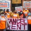 Fani Luna, center, and other Communities for Change activists hold a sign saying cancel rent.