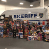 A sheriff's van with illegal fireworks stacked in front of it.