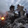People inspect the crash site of MH17 near the village of Grabovo, Ukraine, on July 17, 2014. 