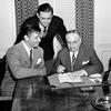 Actor Clark Gable, left, producer David O. Selznick, center, and MGM studio head Louis B. Mayer sign contracts for the movie production of 'Gone With the Wind' in Los Angeles, Ca., Aug. 26, 1938. 