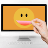 A hand reaching in and adjusting the smile on a smiley-face displayed on a computer monitor.