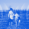 Two children, hand-in-hand, walk toward a barbed-wire fence in the far background.
