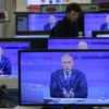 Russian President Vladimir Putin is seen on television screens in a shop as he speaks during an annual call-in show on Russian television/