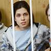 Members of the all-girl punk band 'Pussy Riot' Nadezhda Tolokonnikova (C), Maria Alyokhina (R) and Yekaterina Samutsevich (L), sit behind bars during a court hearing in Moscow on July 20, 2012.