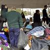 A man sorts through clothes at the Midland Beach FEMA staging area in Staten Island Monday.