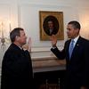 President Barack Obama is given the Oath of Office for a second time by Chief Justice John G. Roberts, Jr. in the Map Room of the White House, Jan. 21, 2009. 