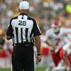 A NFL referee watches as the field.