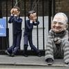 A protester wearing a Rupert Murdoch mask demonstrates with David Cameron and Nick Clegg puppets outside the apartment of the News Corp CEO on July 13, 2011 in London, England.