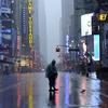 A man walks across 42nd Street in Times Square in New York on August 28, 2011 as Hurricane Irene hits the city and Tri State area with rain and high winds.