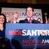 Rick Santorum speaks to supporters as his daughter, Elizabeth (L), and wife, Karen (R), look on February 7, 2012 at the St. Charles Convention Center in St. Charles, Missouri.