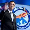 Republican presidential candidate Rick Santorum waves as he arrives to the debate hall on February 22, 2012 in Mesa, Arizona.