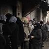 Syrians queue for bread outside a bakery in Qusayr, 15 kms (nine miles) from Homs, on March 1, 2012. Syrian rebels were still holding out more than 24 hours into a ground assault by regime forces aga
