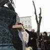 Vladimir Putin lays flowers at a monument to Mstislav Rostropovich on Moscow, on March 29, 2012, with the cellist's widow, Galina Vishnevskaya (R) and daughter, Elena Rostropovich (2R)