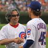 Conductor Riccardo Muti shakes hands with Adrian Cardenas of the Chicago Cubs after throwing out a first pitch at Wrigley Field