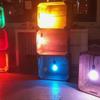 These seven illuminated apple crates are lit with seven colored ceramic light-bulbs. The work is called 'Not Yet Title,' by N.Y.U. student Michelle Lee.