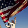Sailors raise an American flag during Veterans Day