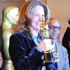 Actress Melissa Leo, who won an Oscar for Best Supporting Actress in The Fighter last year, with the statuette that members of the public can also pose with.