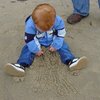 baby playing in a sandbox