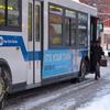 A city bus with chains fitted to the rear wheels travels its route in Brooklyn Wednesday morning.