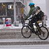 Rain or snow or freezing fog, a New York City bicycle messenger cuts through the slush along 7th Avenue in Manhattan.