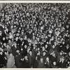 Crowd cheering and holding noise-makers, possibly on New Years, ca. 1945.