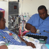 A Shands Hospital staff member plays music for a dialysis patient.