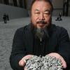 Chinese Artist Ai Weiwei holds some seeds from his Unilever Installation 'Sunflower Seeds' at The Tate Modern.