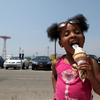 Alani Williams, 4, from Midwood having some ice cream at the beach at Coney Island.