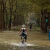 A young man rides his bicycle through flood waters along the East River Bikeway after Hurricane Irene dumped more than six inches of rain August 28, 2011 in New York City. 