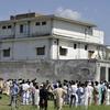 Pakistani media personnel and local residents gather outside the hideout of Al-Qaeda leader Osama bin Laden following his death by US Special Forces in a ground operation in Abbottabad on May 3, 2011.