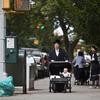 A Hasidic man pushes a stroller near the residence of Leibby Kletzky, a murdered eight-year-old boy who went missing from the Hasidic neighborhood of Borough Park, Brooklyn.