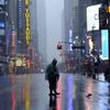 A man walks across 42nd Street in Times Square in New York on August 28, 2011 as Hurricane Irene hits the city and Tri State area with rain and high winds.