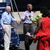 Former US President Jimmy Carter (L) looks on as Aijalon Mahli Gomes is greeted by family members