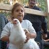 A young chicken fancier with her new friend in the South Bronx