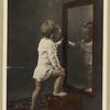 child looking into mirror