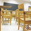 empty wooden desks in a classroom