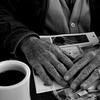 Man drinking coffee in diner