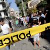 Syrians inspect damage at the site of a car bomb on the southeastern outskirts of the Syrian capital.