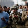  An Egyptian Army soldier prays along with anti-government protesters during the afternoon in Tahrir Square January 30, 2011 in Cairo, Egypt. 