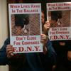 FDNY firefighters hold signs at Monday's City Council meeting