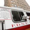 FDNY Engine 55 with an enscription honoring five firefighters killed on September 11, 2001, along with a doll dog in New York City.