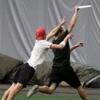 Two Ultimate Disc players race for the frisbee at a new pro game