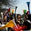 men blowing vuvuzela horns at the 2010 World Cup