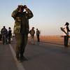 A rebel fighter scans the horizon for government troops on March 3, 2011 in Ajdabiya, Libya.