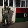 A Libyan opposition army soldier poses outside an army barrack in Benghazi on March 1, 2011.
